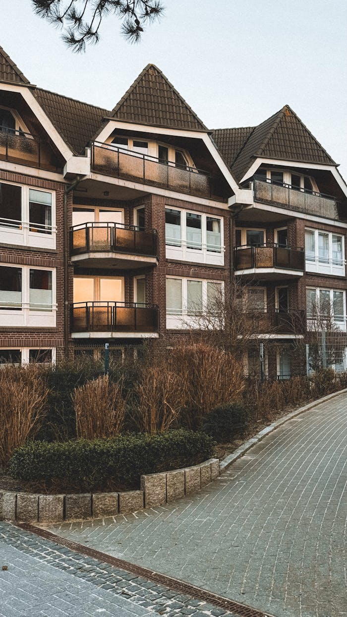 ours-journey Elegant residential building with geometric roofs and balconies, perfect for urban living.