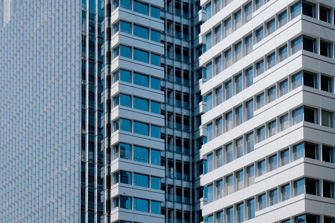 our-experience Sleek modern high-rise building with glass windows and geometric design.